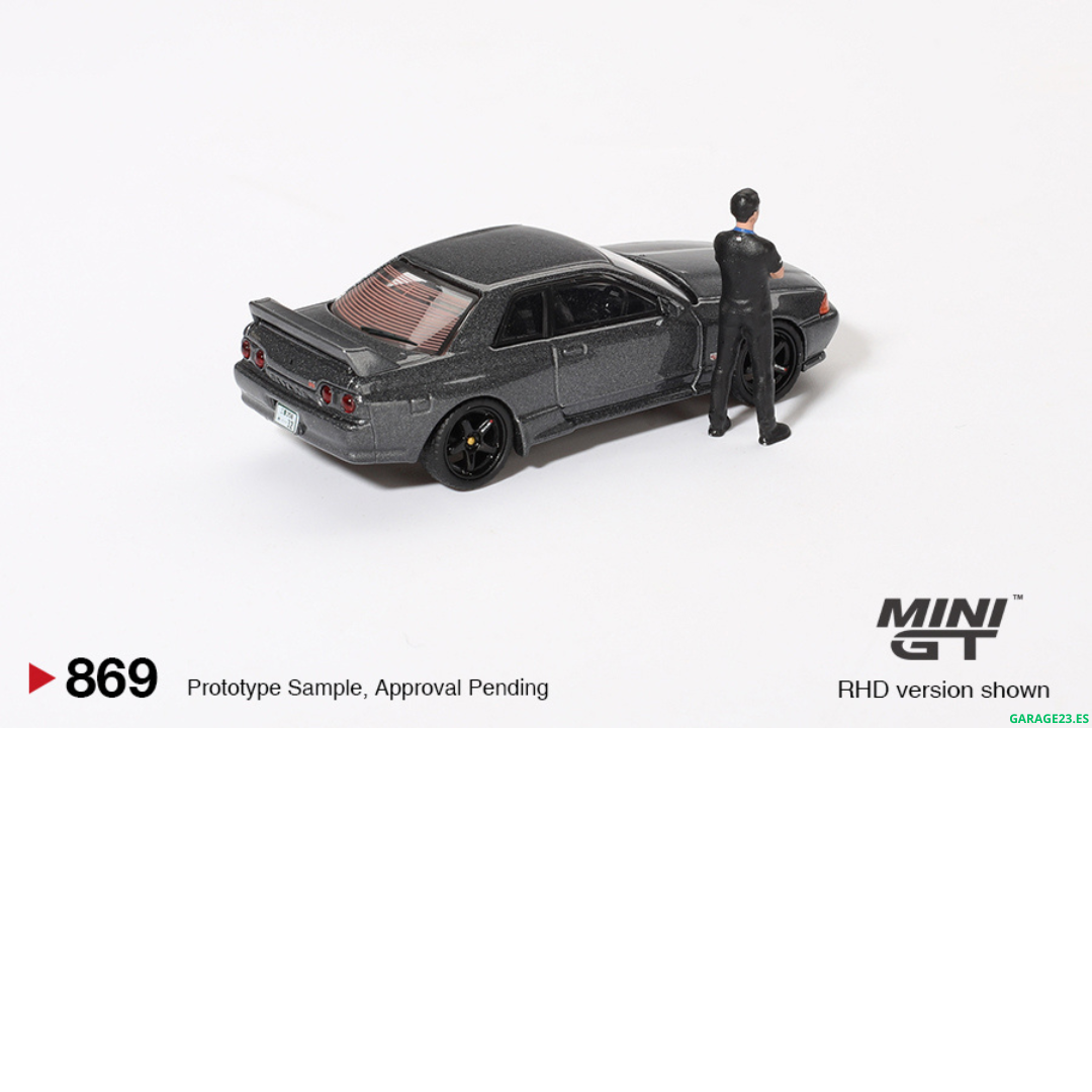 ***EN CAMINO*** MINI GT 1:64 NISSAN SKYLINE GTR R32 NISMO NISMO GUNMETAL CON FIGURA TSUGIO MATSUDA #869