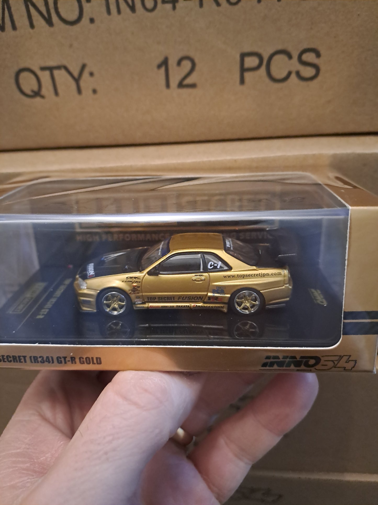 Inno64 Nissan Skyline GTR R34 Top Secret Gold 1.64